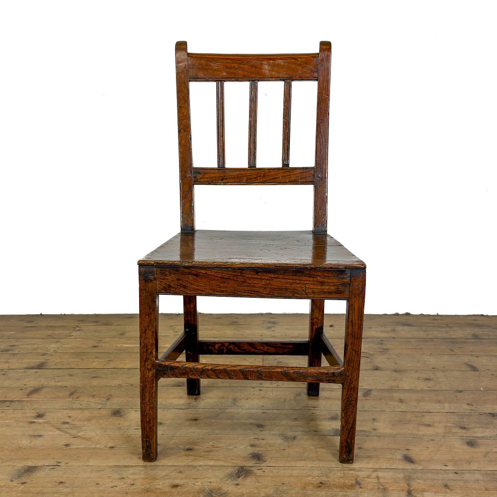 A set of three dark oak farmhouse dining chairs featuring vertical slat backs, solid wooden seats, and sturdy square stretchers. View VI