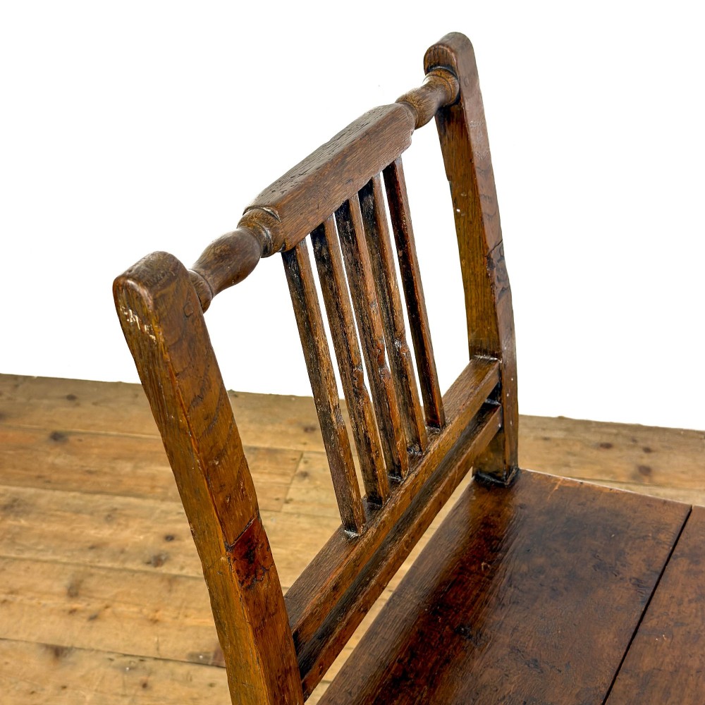 A set of three dark oak farmhouse dining chairs featuring vertical slat backs, solid wooden seats, and sturdy square stretchers. View X