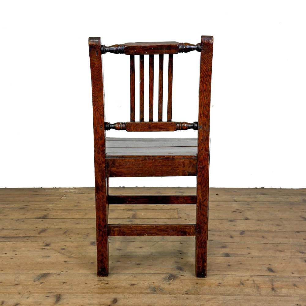 A set of three dark oak farmhouse dining chairs featuring vertical slat backs, solid wooden seats, and sturdy square stretchers. View XII