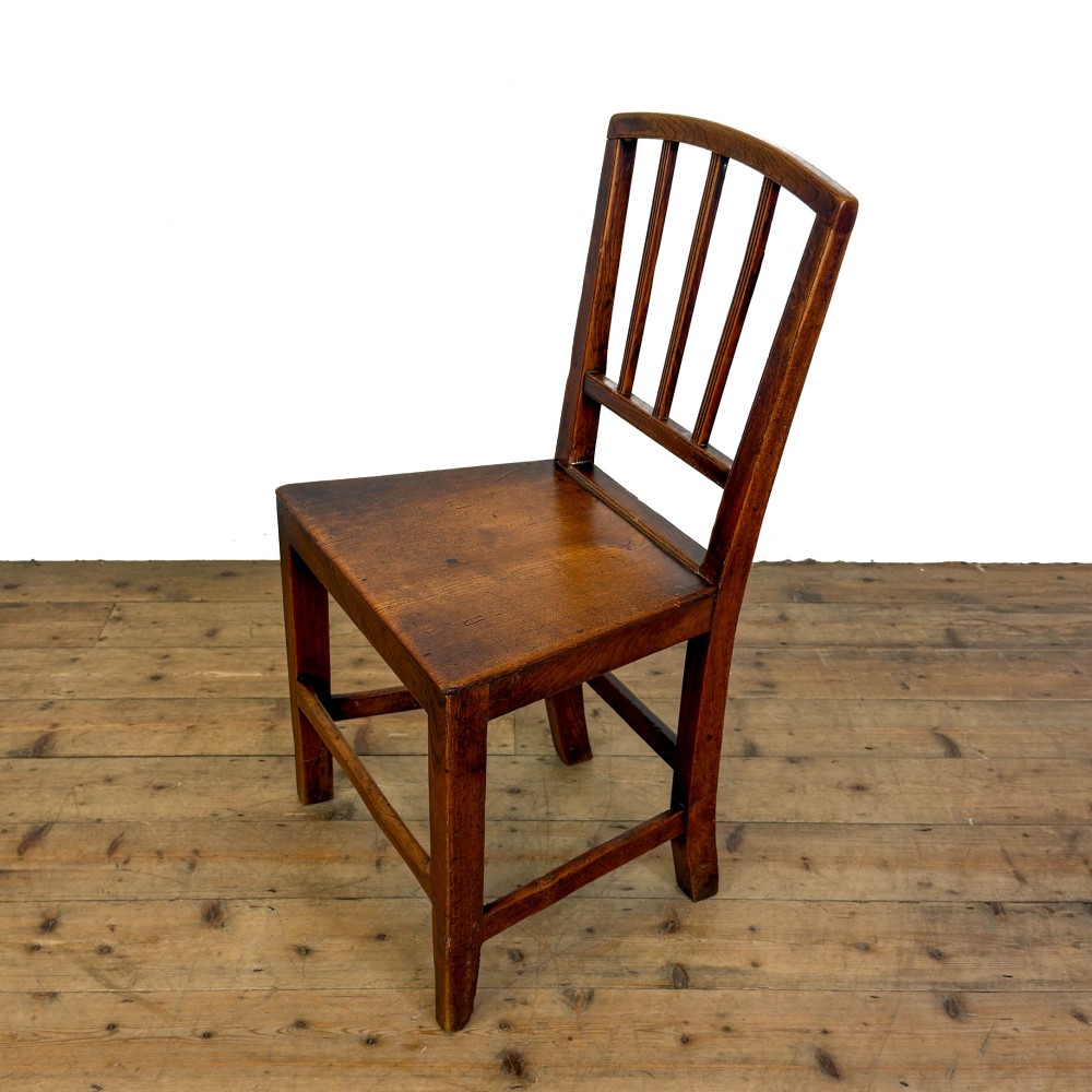 A set of four dark oak dining chairs with vertical slat backrests, solid timber seats, and straight square legs joined by stretchers. View V