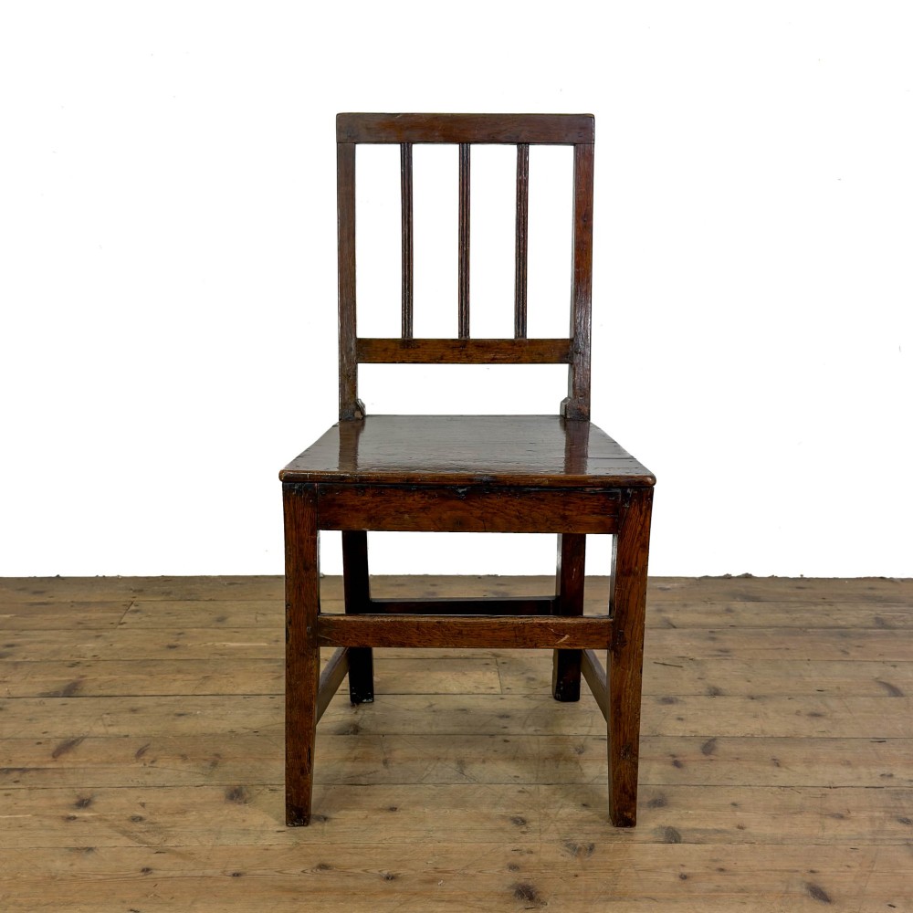 A set of four dark oak dining chairs with vertical slat backrests, solid timber seats, and straight square legs joined by stretchers. View VIII