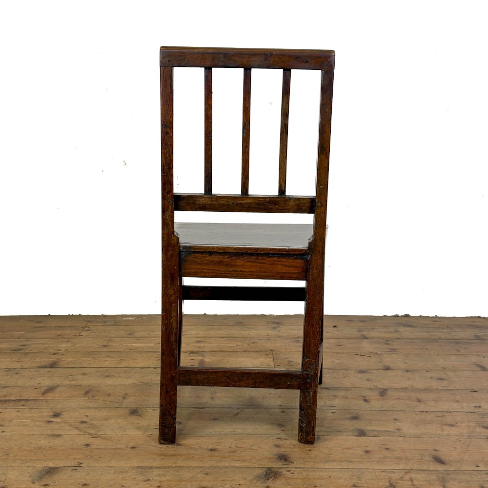 A set of four dark oak dining chairs with vertical slat backrests, solid timber seats, and straight square legs joined by stretchers. View X