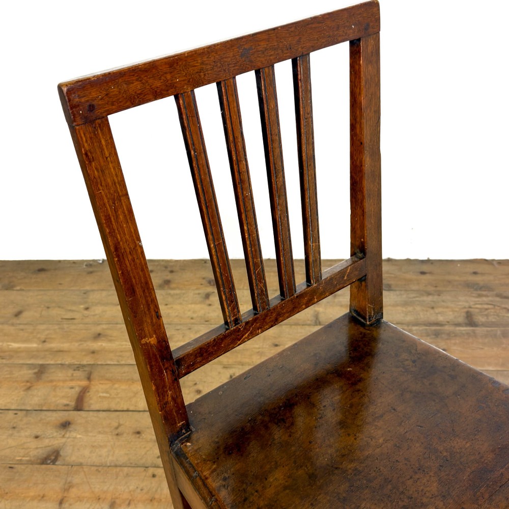 A set of four dark oak dining chairs with vertical slat backrests, solid timber seats, and straight square legs joined by stretchers. View XIV
