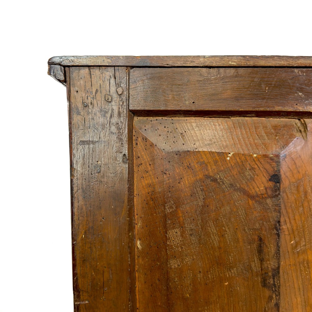 An antique Georgian oak dresser base with multiple drawers, fielded panel cupboard doors, and brass swan-neck handles on a bracket feet base. View XI