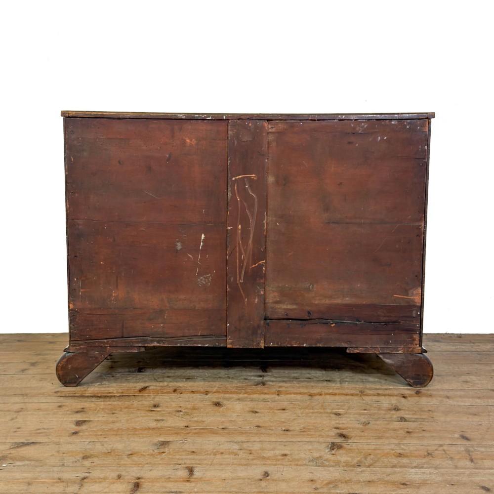 A William IV dark mahogany chest of drawers featuring three long drawers with turned knobs, brass escutcheons, and carved scroll feet. View VI