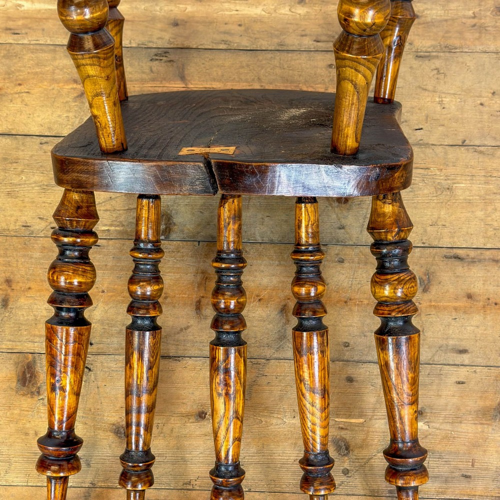 A matching set of four wooden farmhouse kitchen chairs featuring turned spindle backs, contoured seats, and turned legs connected by H-stretchers. View III