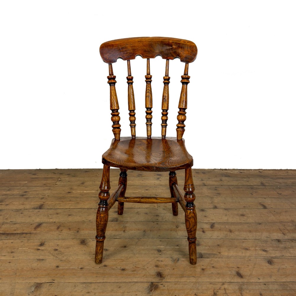 A matching set of four wooden farmhouse kitchen chairs featuring turned spindle backs, contoured seats, and turned legs connected by H-stretchers. View IV