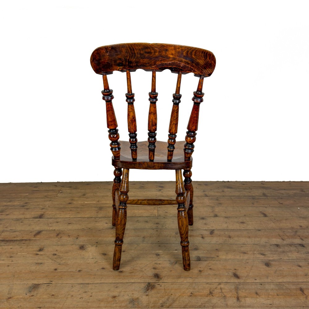 A matching set of four wooden farmhouse kitchen chairs featuring turned spindle backs, contoured seats, and turned legs connected by H-stretchers. View V