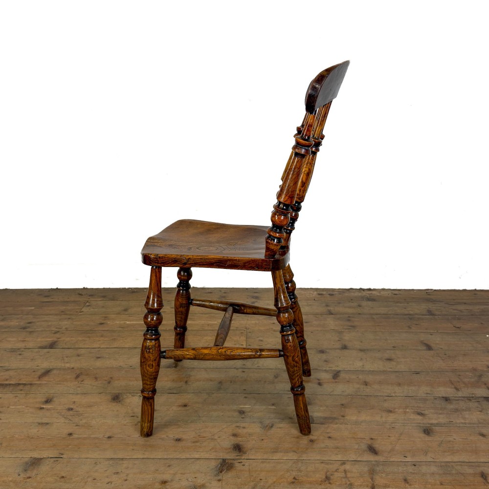 A matching set of four wooden farmhouse kitchen chairs featuring turned spindle backs, contoured seats, and turned legs connected by H-stretchers. View IX