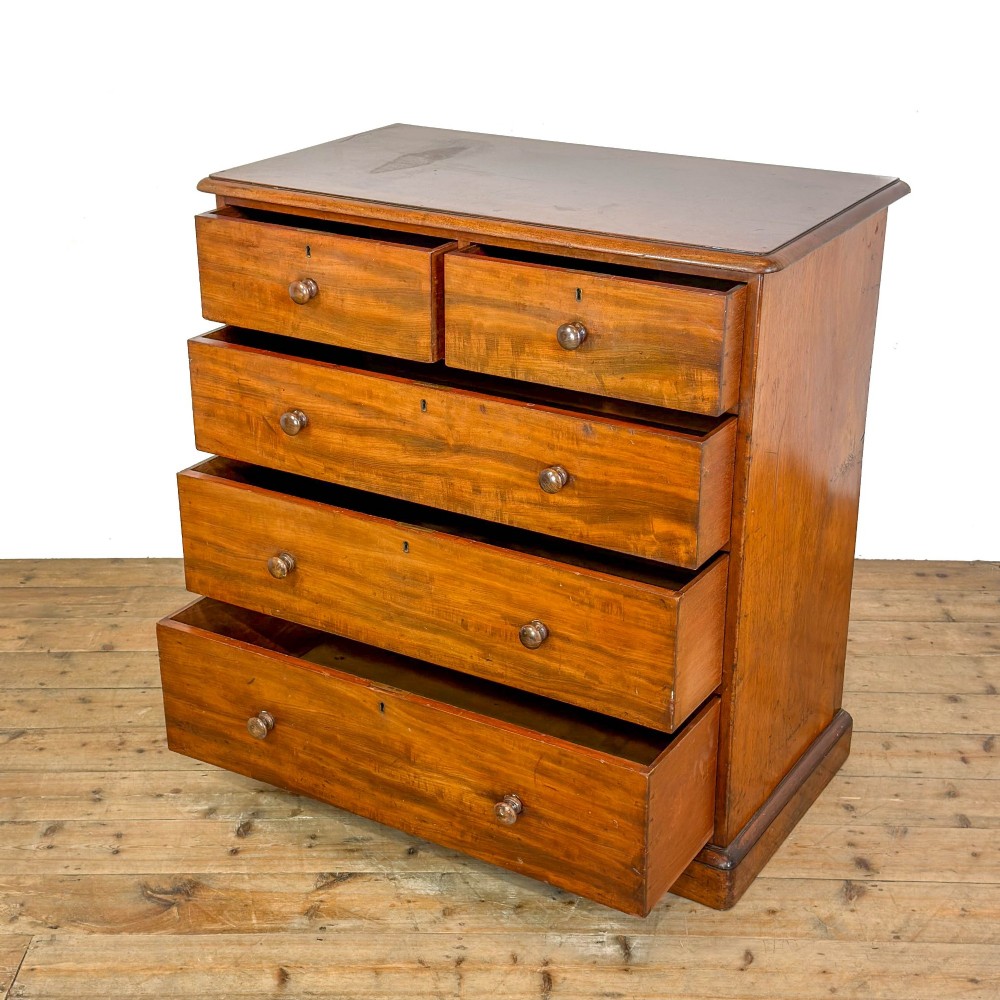 A 19th-century mahogany chest of drawers featuring two short drawers over three long drawers with turned wooden knobs and a solid plinth base. View II