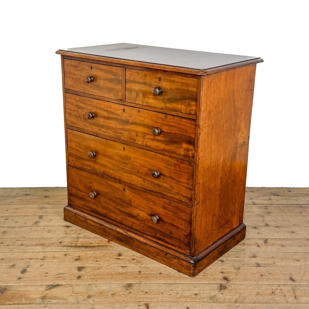 A 19th-century mahogany chest of drawers featuring two short drawers over three long drawers with turned wooden knobs and a solid plinth base. View III