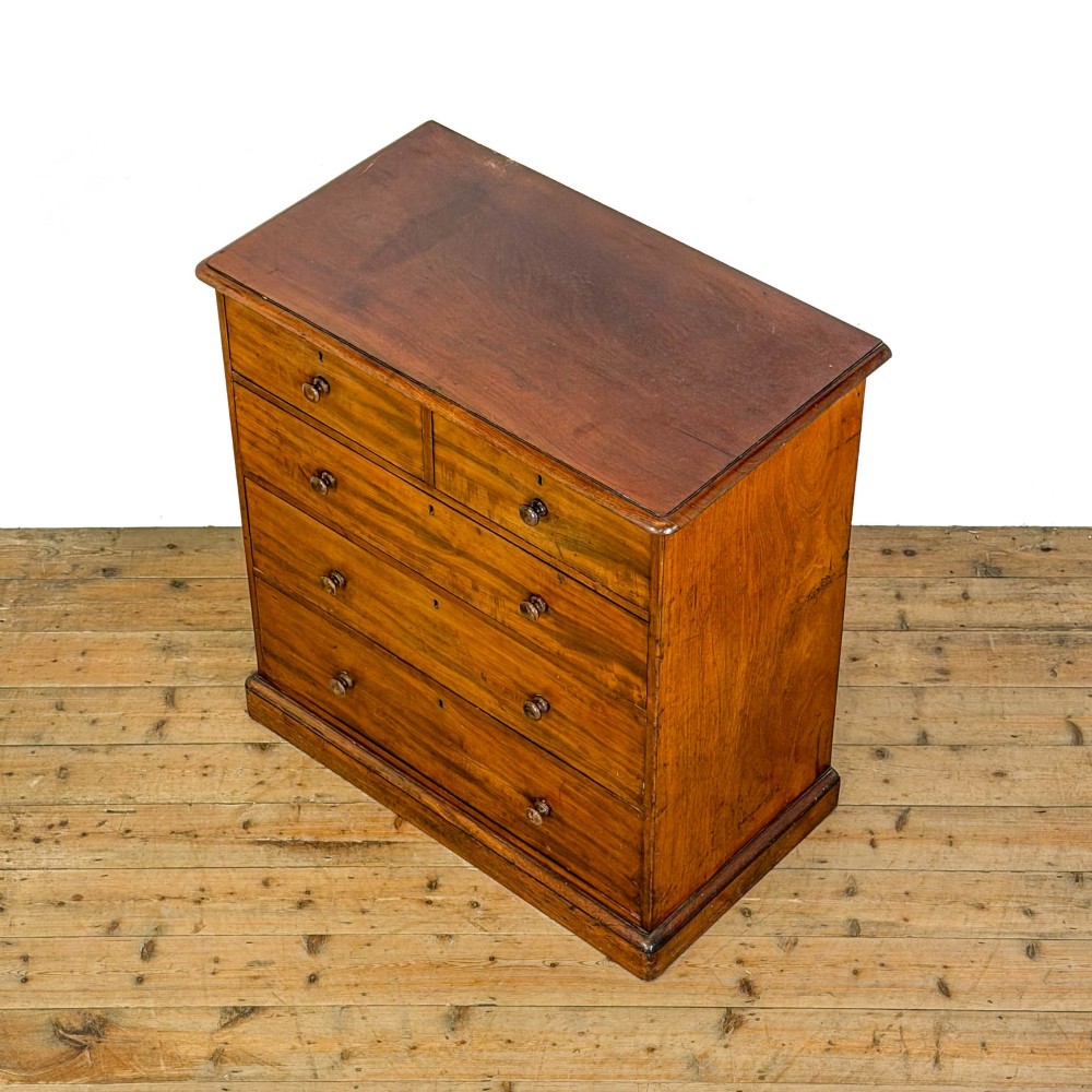 A 19th-century mahogany chest of drawers featuring two short drawers over three long drawers with turned wooden knobs and a solid plinth base. View IV