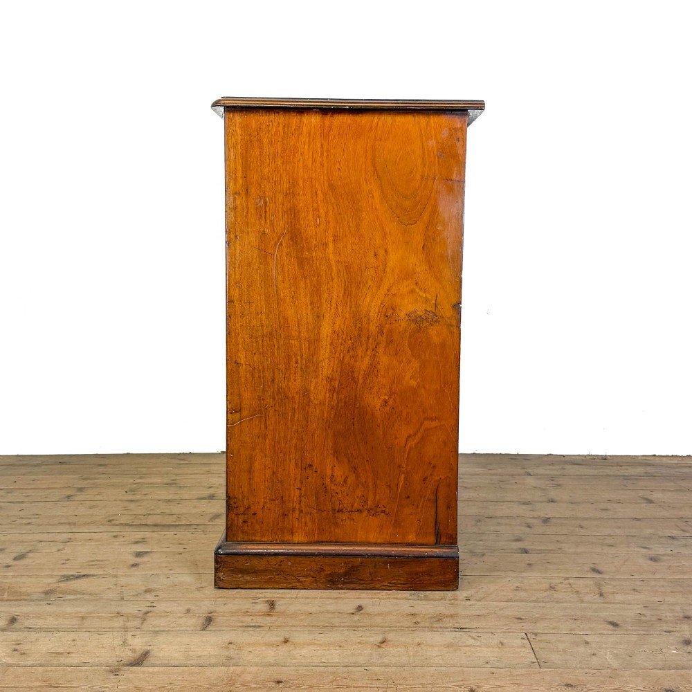 A 19th-century mahogany chest of drawers featuring two short drawers over three long drawers with turned wooden knobs and a solid plinth base. View V