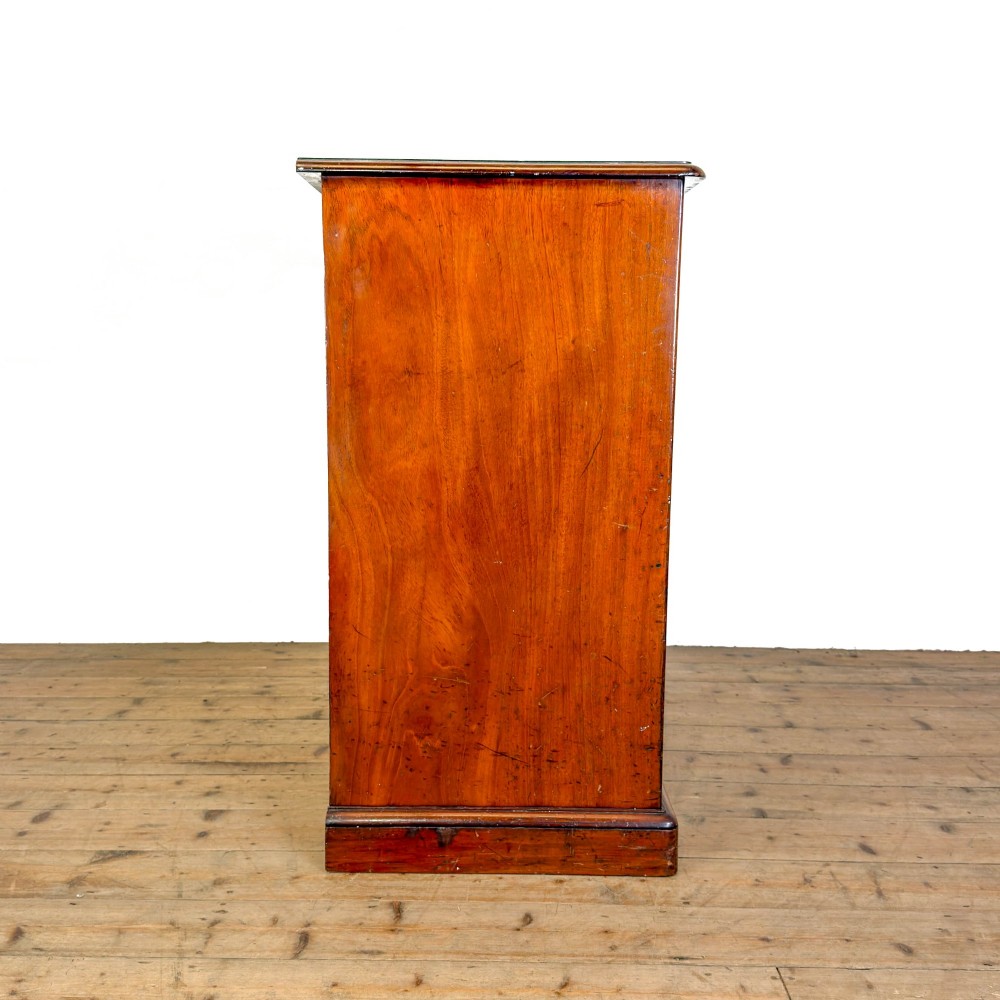 A 19th-century mahogany chest of drawers featuring two short drawers over three long drawers with turned wooden knobs and a solid plinth base. View VII