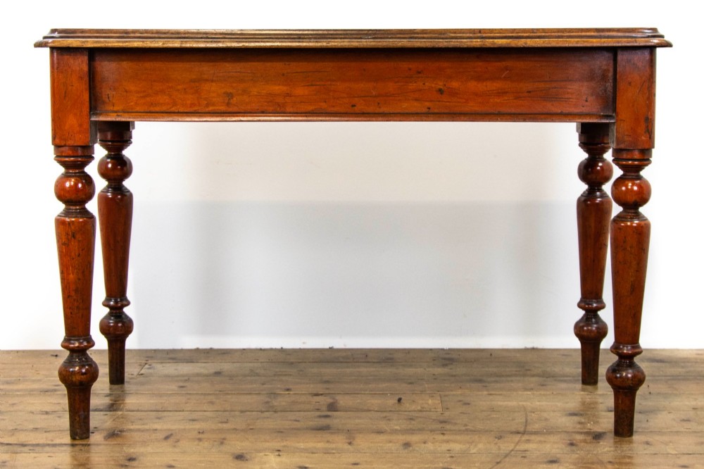 An antique mahogany console table featuring a rectangular top with moulded edges supported by four turned wooden legs. View II