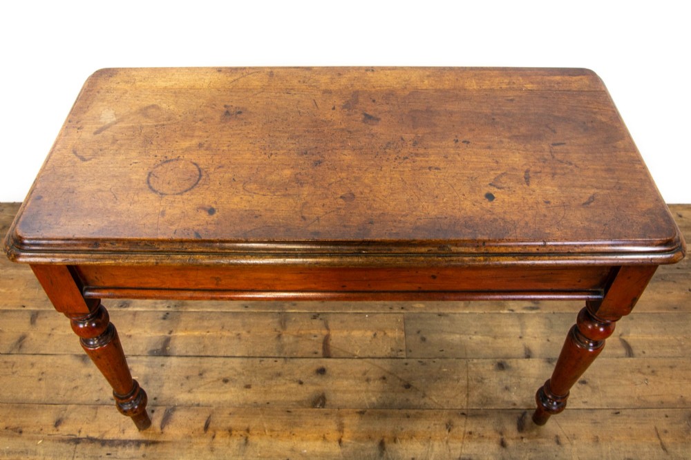 An antique mahogany console table featuring a rectangular top with moulded edges supported by four turned wooden legs. View III