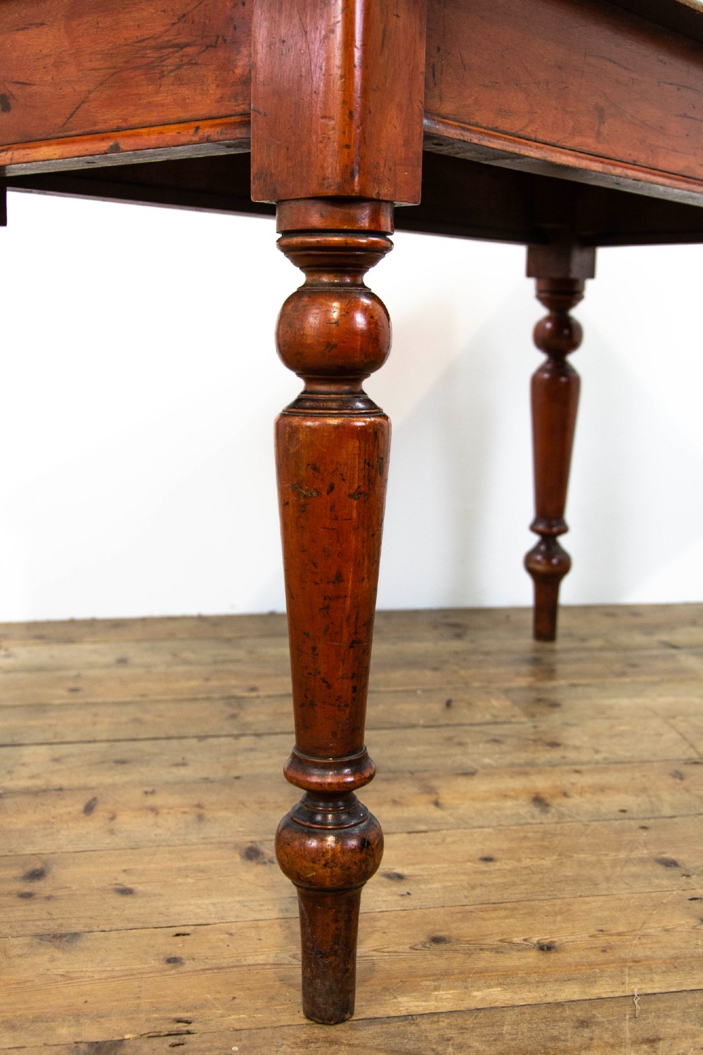 An antique mahogany console table featuring a rectangular top with moulded edges supported by four turned wooden legs. View V