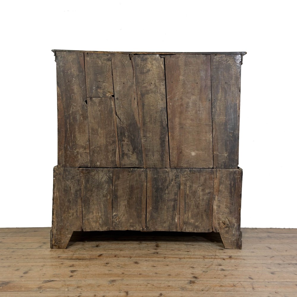 An 18th-century Welsh dark oak Carmarthenshire coffer featuring upper cupboard doors with pointed arch fielded panels above multiple drawers fitted with brass knobs. View VII