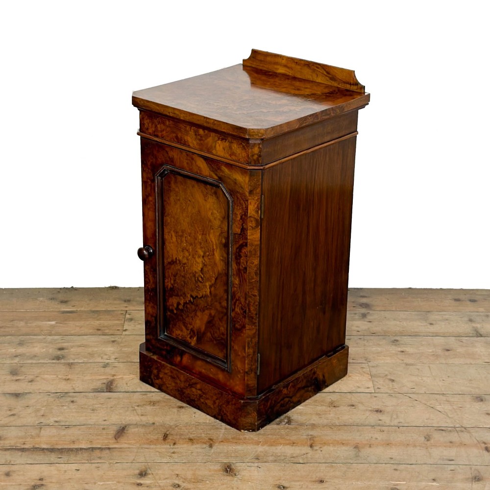 A Victorian burr walnut pot cupboard featuring a single panelled door with a turned wooden knob, chamfered corners, and a solid plinth base. View III