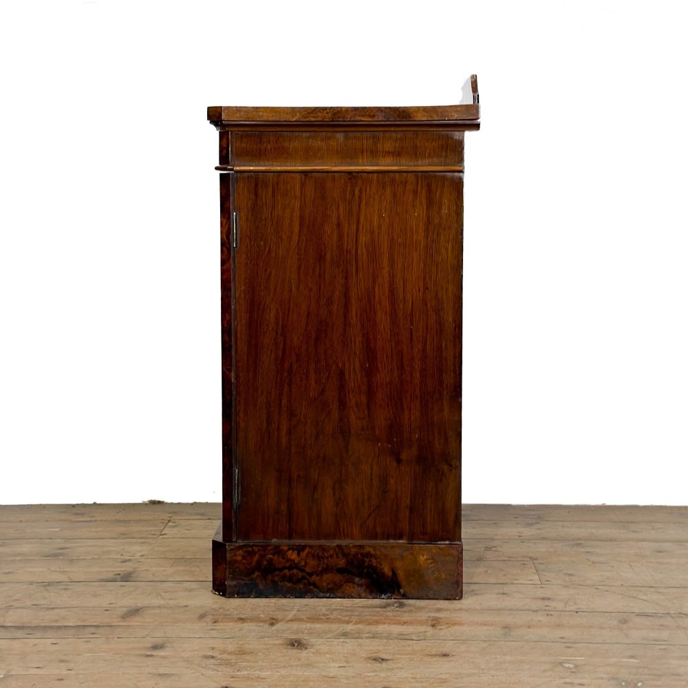 A Victorian burr walnut pot cupboard featuring a single panelled door with a turned wooden knob, chamfered corners, and a solid plinth base. View IV