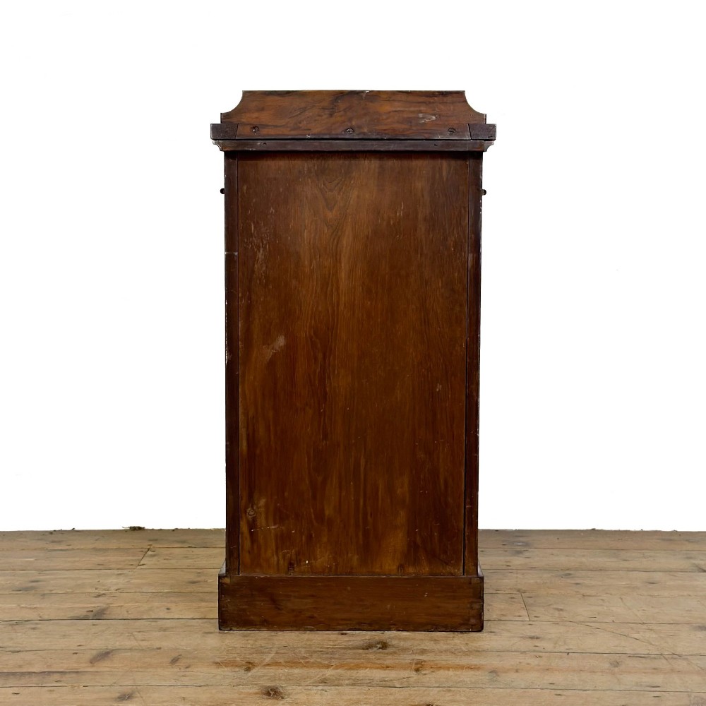 A Victorian burr walnut pot cupboard featuring a single panelled door with a turned wooden knob, chamfered corners, and a solid plinth base. View VI