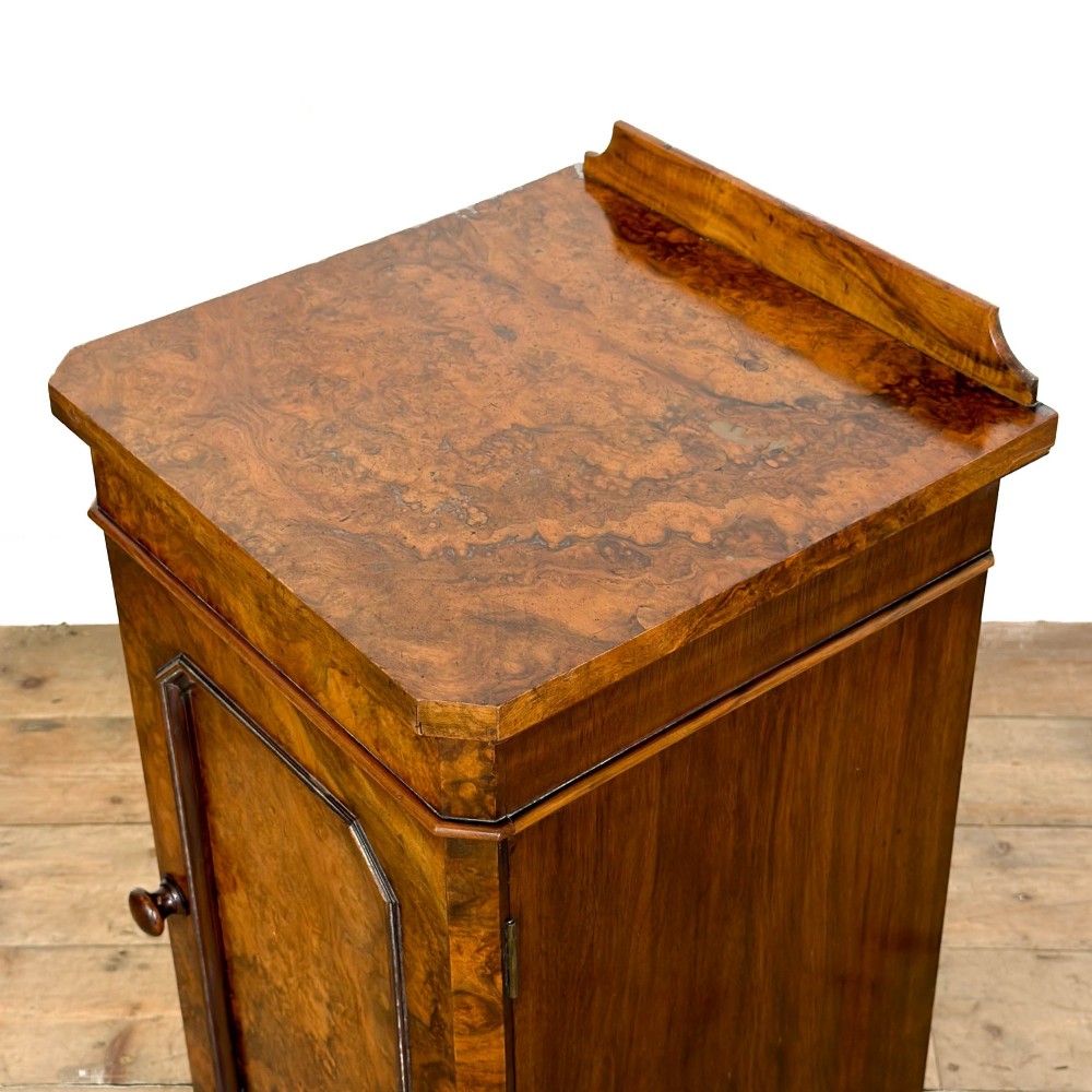 A Victorian burr walnut pot cupboard featuring a single panelled door with a turned wooden knob, chamfered corners, and a solid plinth base. View VIII