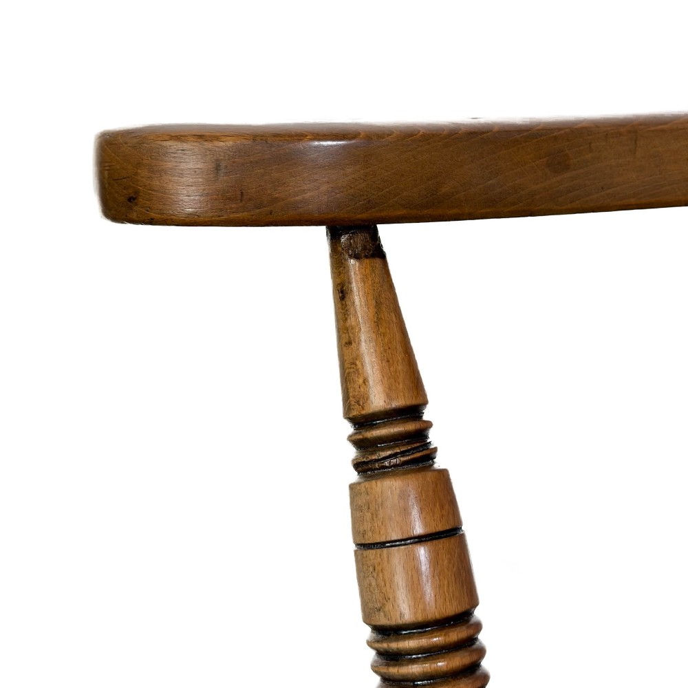 A warm brown wooden smokers bow armchair featuring turned legs, vertical back spindles, a steam-bent curved top rail, and a shaped solid seat. View II