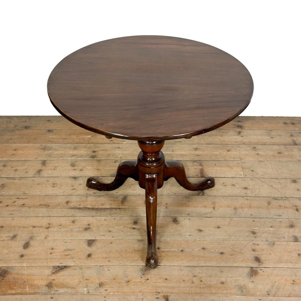 An antique mahogany tilt-top occasional table featuring a round circular top, turned central column pedestal, and three splayed cabriole legs with pad feet. View II