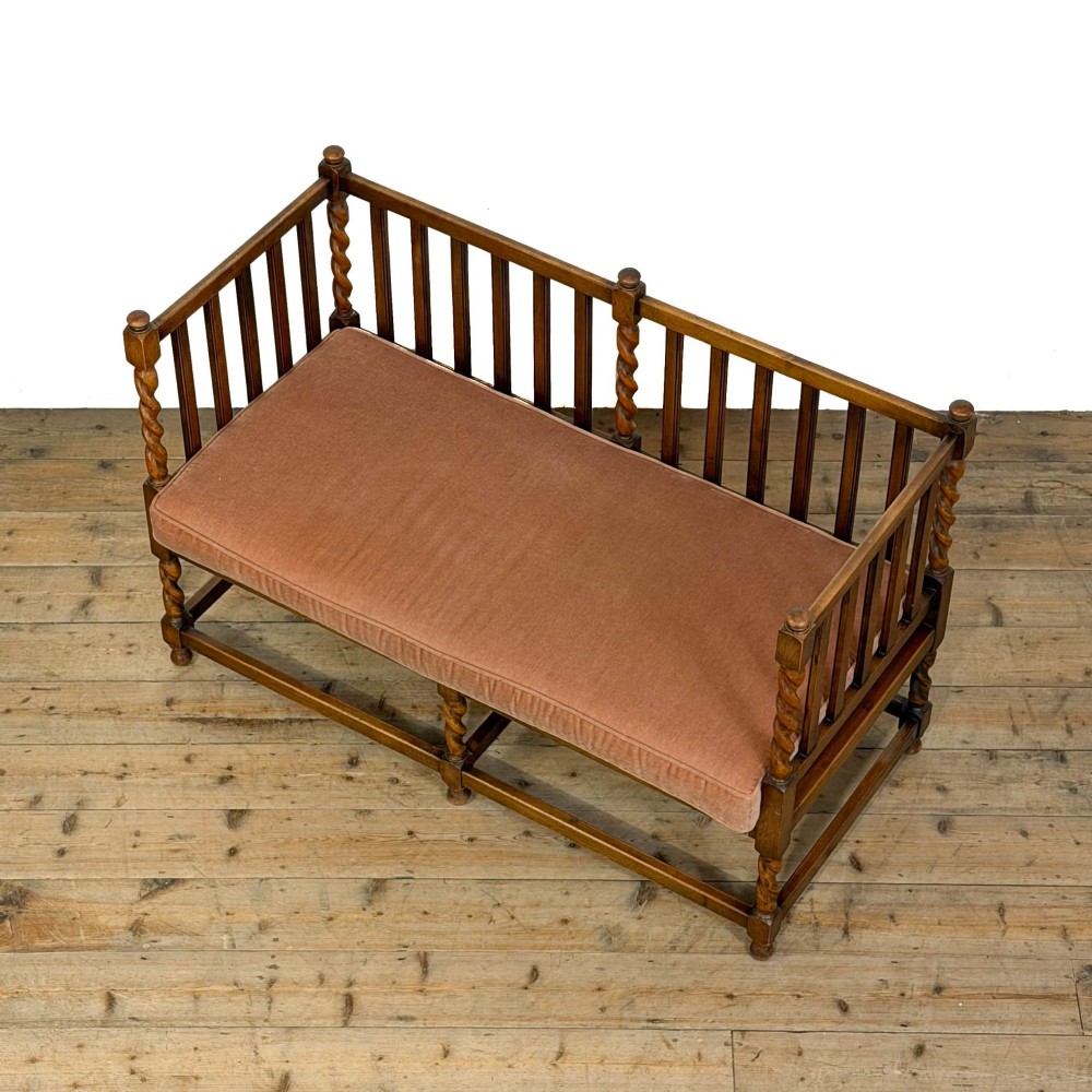 An Arts and Crafts style oak hall bench featuring barley twist legs and side posts, a vertical slat backrest, and a terracotta-coloured cushion. View VIII