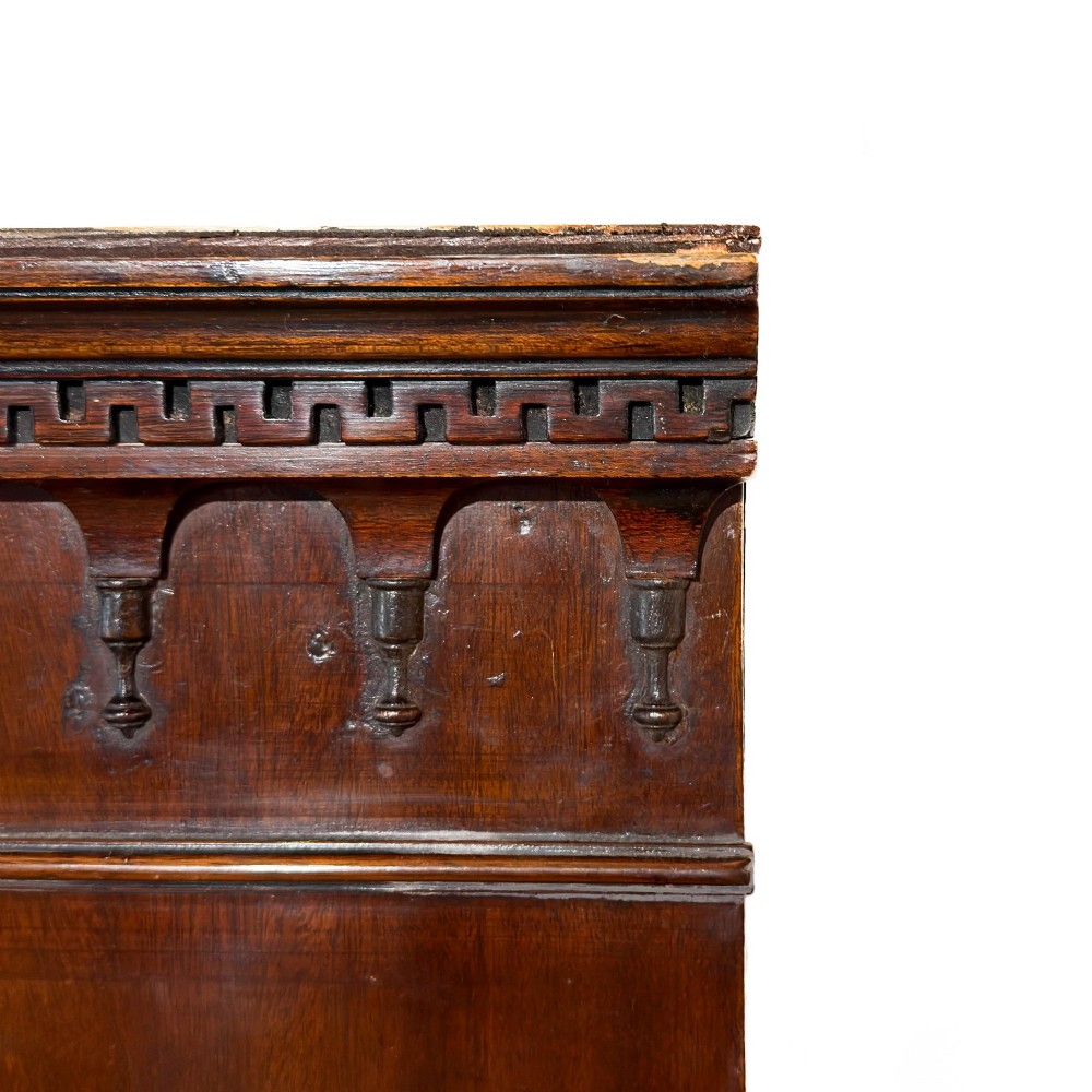 A tall mahogany serpentine chest on chest featuring two stacked sections of graduating drawers with brass handles and carved cornice detail. View IX