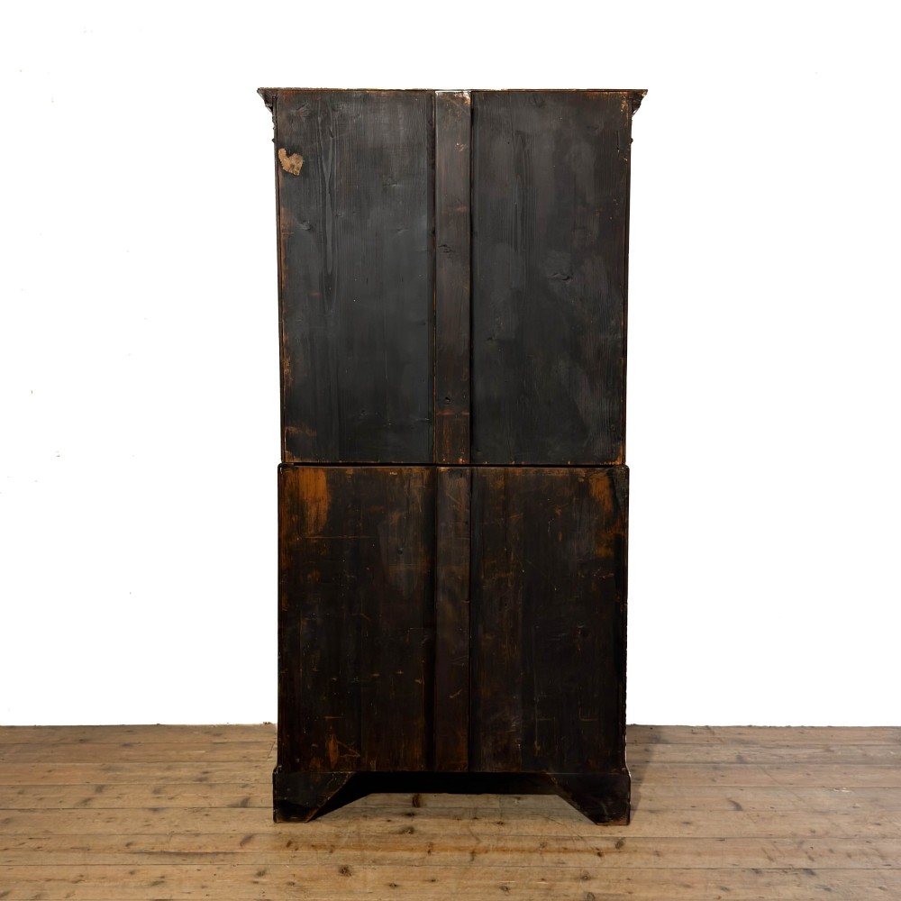A tall mahogany serpentine chest on chest featuring two stacked sections of graduating drawers with brass handles and carved cornice detail. View X