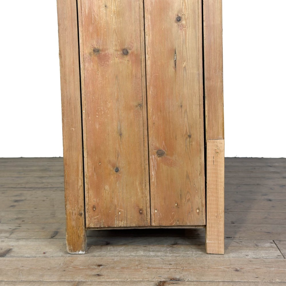A tall Victorian pine kitchen dresser with open plate shelving, cup hooks, two drawers, panelled doors, and a central open alcove. View VII