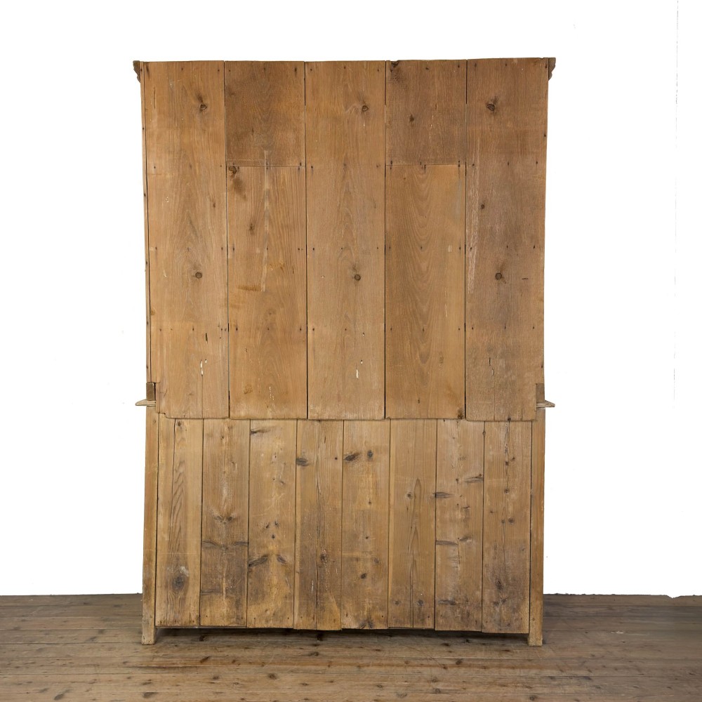 A tall Victorian pine kitchen dresser with open plate shelving, cup hooks, two drawers, panelled doors, and a central open alcove. View X