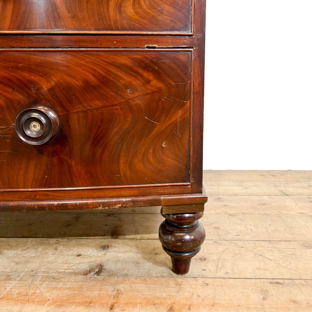 A Victorian mahogany bow front chest of drawers with two short over three long drawers, turned wooden knobs, and turned feet. View IV