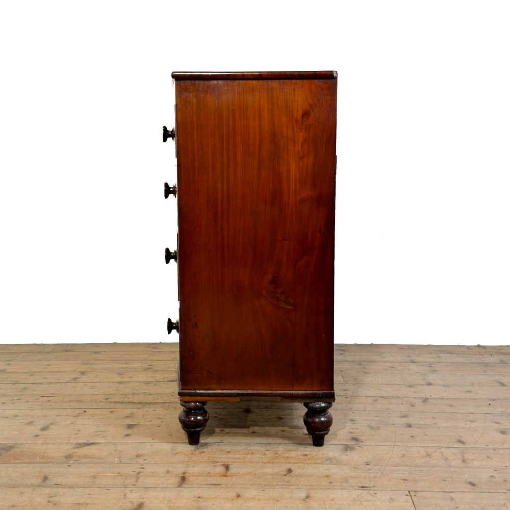 A Victorian mahogany bow front chest of drawers with two short over three long drawers, turned wooden knobs, and turned feet. View V