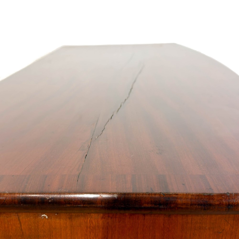 A Victorian mahogany bow front chest of drawers with two short over three long drawers, turned wooden knobs, and turned feet. View VIII