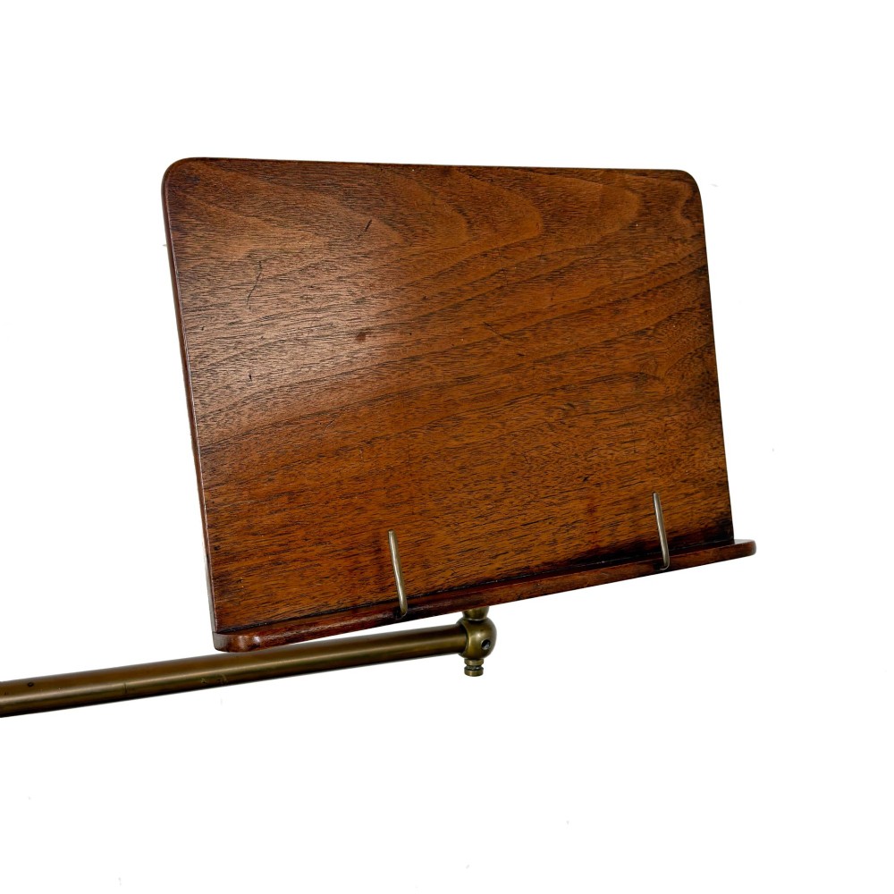 A Victorian adjustable reading stand featuring a cast iron decorative base, a brass column with an articulated swing arm, and a rectangular mahogany book rest. View II