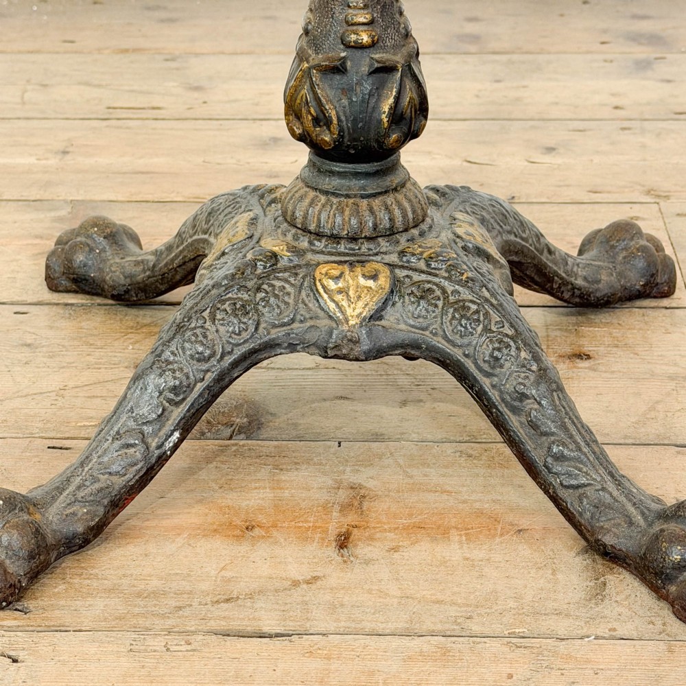 A Victorian adjustable reading stand featuring a cast iron decorative base, a brass column with an articulated swing arm, and a rectangular mahogany book rest. View V