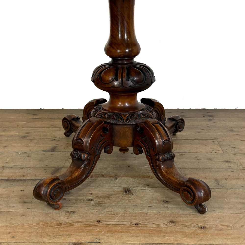 An antique Victorian walnut foldover card table featuring a rectangular swivel top, turned central column, and carved scroll feet. View XII