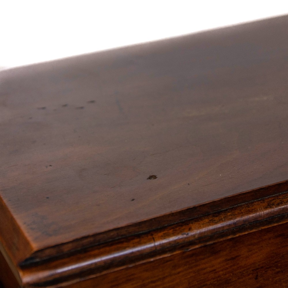 An antique Victorian walnut Sutherland table featuring turned legs, a drop-leaf top, a cross stretcher, and small castors. View II