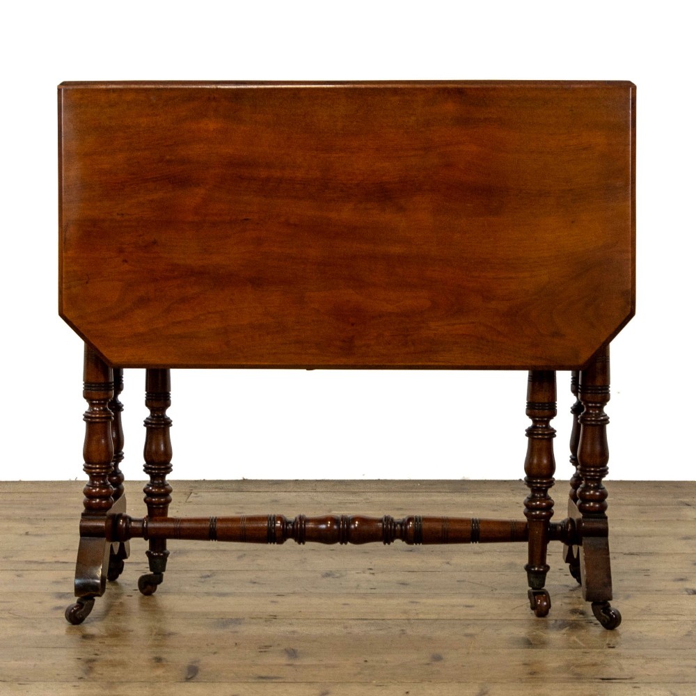 An antique Victorian walnut Sutherland table featuring turned legs, a drop-leaf top, a cross stretcher, and small castors. View VIII