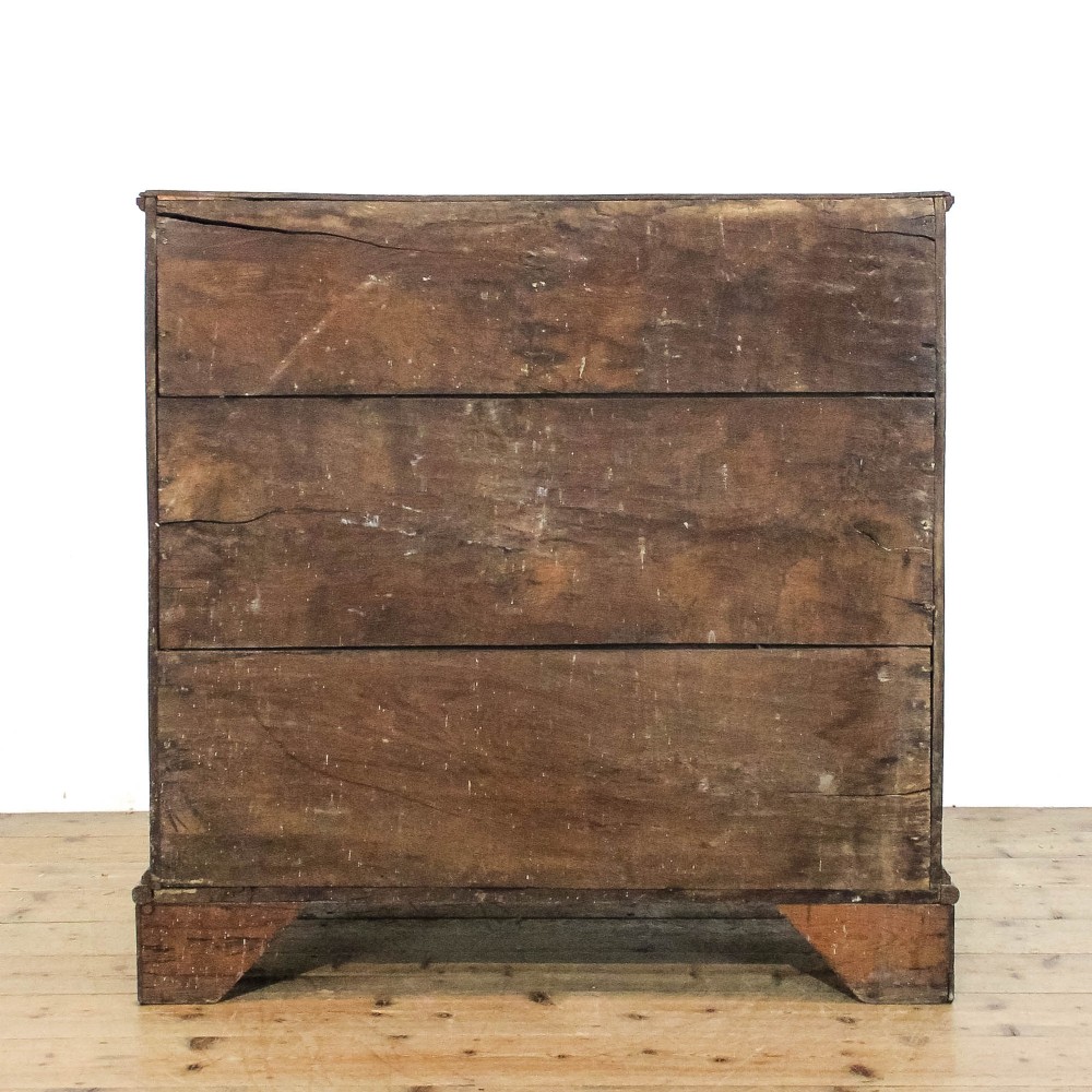 An eighteenth-century dark oak chest of drawers featuring a two-over-three drawer configuration, brass swan-neck handles, decorative keyhole escutcheons, and shaped bracket feet. View IV