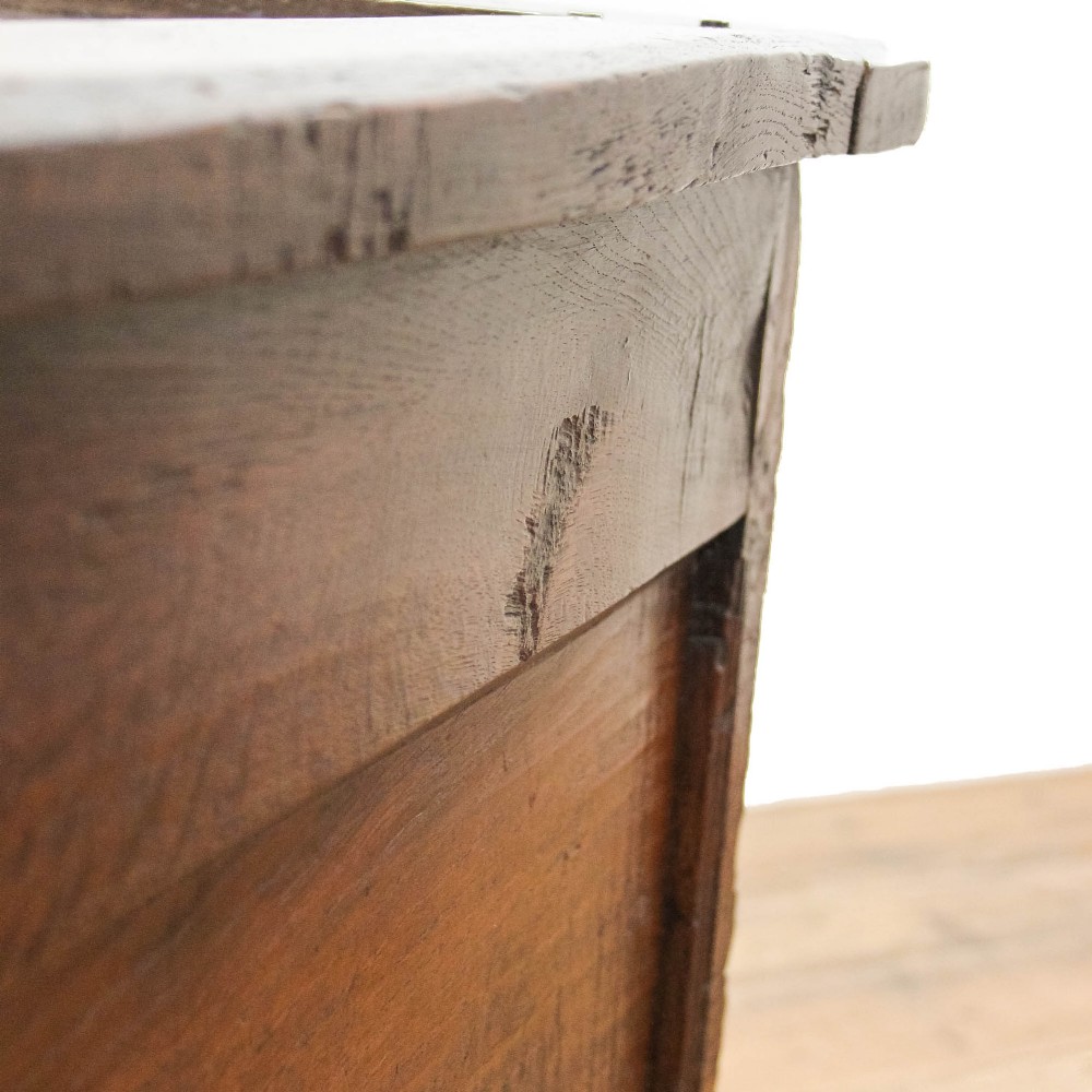 A dark carved oak coffer featuring three front panels, geometric inlay along the frame, arcaded frieze carvings, and a central iron keyhole plate. View II