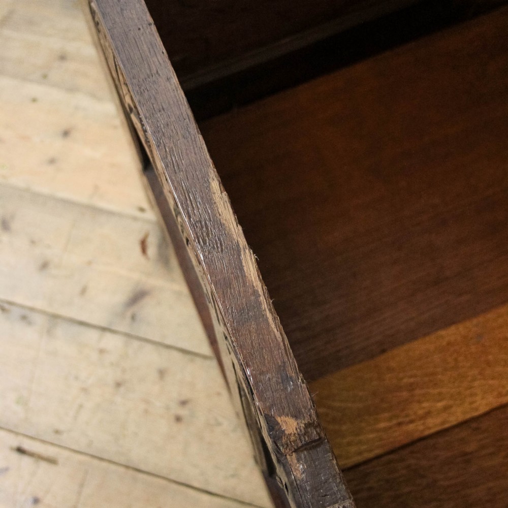 A dark carved oak coffer featuring three front panels, geometric inlay along the frame, arcaded frieze carvings, and a central iron keyhole plate. View XI