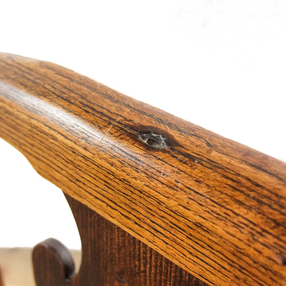 A George III period oak open armchair featuring a pierced vase-shaped back splat, swept arms, a solid wooden seat, and square legs joined by stretchers. View IX