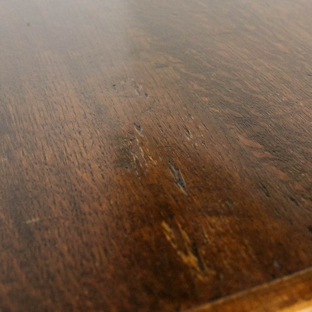 An antique dark oak kitchen table featuring a rectangular top, an end drawer with a brass knob, straight legs, and a low H-stretcher base. View IV