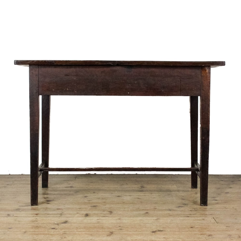 An antique dark oak kitchen table featuring a rectangular top, an end drawer with a brass knob, straight legs, and a low H-stretcher base. View VII