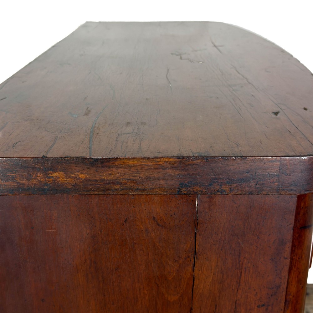 A Victorian mahogany chest of drawers featuring a bowfront profile, two short over three long graduating drawers, turned wooden knobs, and turned feet. View VII