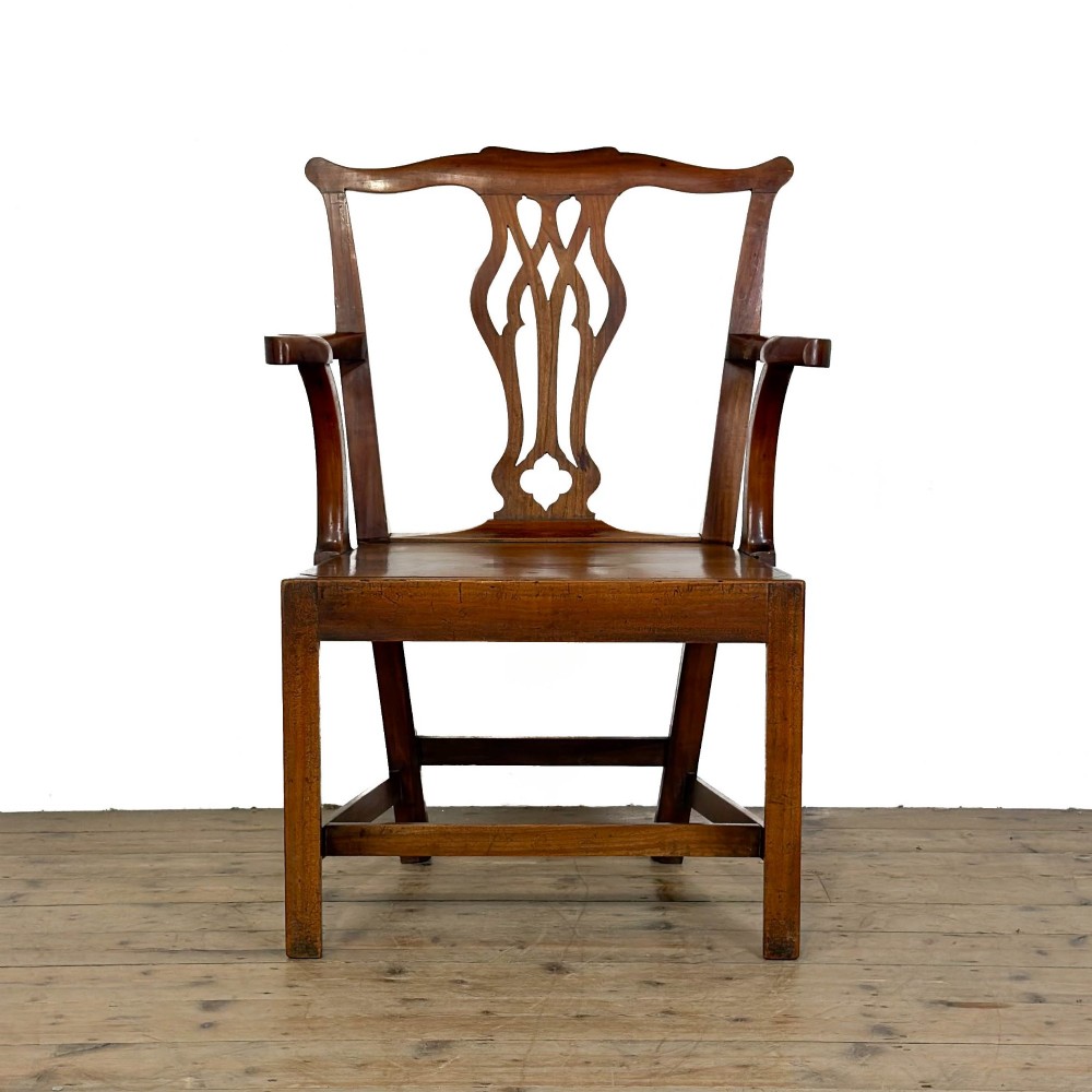 An antique fruitwood armchair in the Chippendale style featuring a pierced back splat, shaped armrests, a solid wood seat, and square legs with stretchers. View II