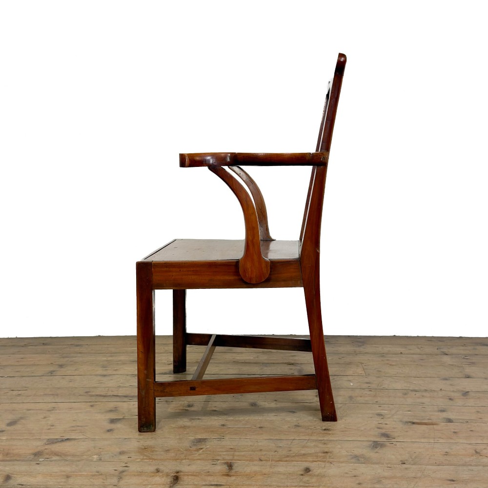 An antique fruitwood armchair in the Chippendale style featuring a pierced back splat, shaped armrests, a solid wood seat, and square legs with stretchers. View V